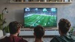 © Space Priest - Three men are watching a soccer game on a large television, football on TV