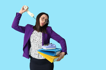 Wall Mural - Funny tired businesswoman with telephone cord around her neck on blue background