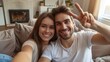 © Oulaphone - Joyful young man making selfie with his beautiful girlfriend at home. Couple with smile and joy in their eyes.