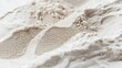 © AkuAku - Close up image of kinetic sand on a white background