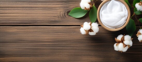 Poster - A flat lay of organic cosmetic products featuring cotton flower green leaves and a wooden background Ample copy space provided