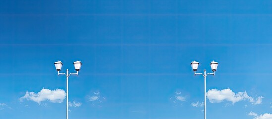 Canvas Print - A triple street lamp stands against a vibrant blue sky with ample space available on the right for a copy space image