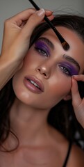 Wall Mural - A close-up of a model with purple eyeshadow and long lashes