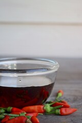 Poster - Fish sauce with red chili on wood table