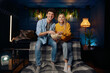 © Nomad_Soul - A man and a woman are sitting on a couch, smiling and enjoying popcorn