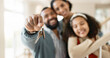 © peopleimages.com - Parents, girl and hands with keys in new home or apartment, relocation and property purchase for investment or achievement. Mom, dad and child together with mortgage loan, milestone and celebration.