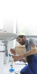 Wall Mural - Plumber working on a bathroom sink