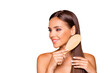 © deagreez - Portrait of charming well-groomed dreamy brunette hair lady with her naked shoulders she combing hair with wooden brush isolated on pastel beige background make white beaming teeth toothy smile