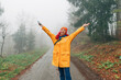 © EdNurg - Amidst the fall foliage, a young woman explores the national park, hiking along a foggy walkway and immersing herself in the tranquil atmosphere of the misty forest.