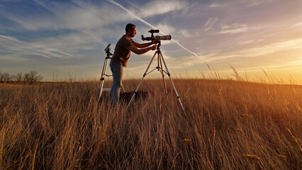 Wall Mural - amateur astronomer observing suolar eclipse and sun with a telescope and special solar filter.