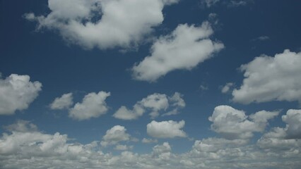 Wall Mural - beautiful cumulus clouds on a blue sky - time lapse video, slow movement of white clouds across the 