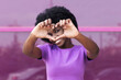 © VISTA by Westend61 - Smiling young woman showing heart shape with hands