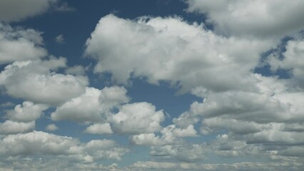 Wall Mural - Beautiful cumulus clouds on a blue sky - time lapse video, slow movement of white clouds across the sky on a sunny spring day, nature weather blue sky, beautiful background for your projects.