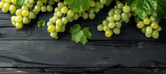 Wall Mural - Gray-green grapes on a black wooden surface. place for text. View from above. 