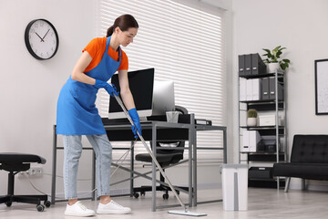 Canvas Print - Cleaning service. Woman washing floor with mop in office