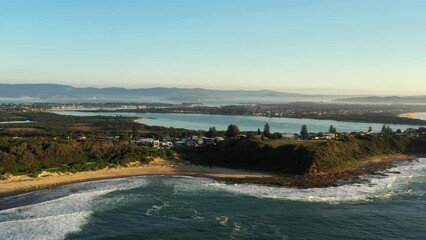 Poster - Aerial panning along Pacific coast of Caves beach town in NSW of Australia.
