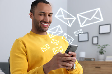 Wall Mural - Smiling man with smartphone chatting indoors. Many illustrations of envelope as incoming messages out of device