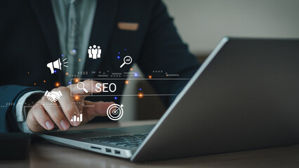Wall Mural - businessman using a computer for analysis seo search engine optimization marketing ranking traffic w