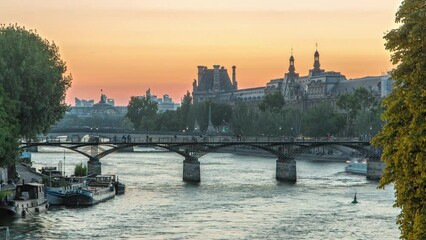 Wall Mural - Pont des Arts in Paris after sunset day to night transition timelapse from Pont Neuf, France. Ship on the River Seine near square of the Vert-Galant. View from above with reflection on water