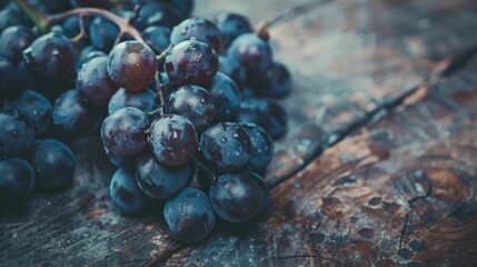 Wall Mural - Fresh ripe red grapes on a textured wooden surface.

