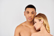 © LIGHTFIELD STUDIOS - Attractive man and woman elegantly pose in front of white backdrop.