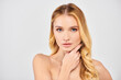 © LIGHTFIELD STUDIOS - Young woman strikes a thoughtful pose with hand resting on chin.