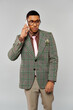 © LIGHTFIELD STUDIOS - Stylish man in checkered blazer talking on cell phone.