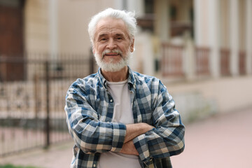 Wall Mural - Portrait of happy grandpa with grey hair outdoors