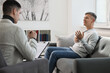 © New Africa - Professional psychotherapist working with patient in office
