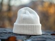 © CG Design - Close-up of a blank white beanie mockup placed on a wooden table