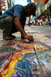 © AI_images_for_people - an artist creating a large chalk mural on a city sidewalk