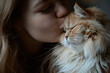 © Klay - affectionate moment of young woman gently kissing her fluffy persian cat in a soft, intimate indoor setting