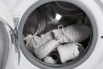 Canvas Print - Stylish clean sneakers inside modern washing machine