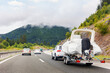 © Kyryl Gorlov - Modern luxury SUV towing yacht boat trailer carrier go river lake sea vacation mountain highway road summer light. Luxury rich fishing leisure recreation lifestyle. Service maintenance transportation