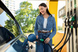 © Home-stock - Woman refilling auto with bio fuel at modern petrol station. Eco friendly and convenient car care, automobile fueling offer concept