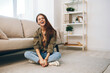 © SHOTPRIME STUDIO - Chill and Smile: Happy Woman Relaxing on Cosy Sofa in Modern Apartment