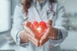 © Valentin - Female scientist holding heart with network in lab coat