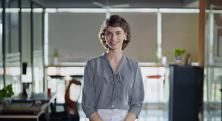 young adult gen z cute girl client in formal dress real estate agent standing proud look cam indoor 