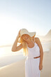 © Grady Reese/peopleimages.com - Travel, portrait and woman at beach with hat for summer vacation, holiday trip or tropical getaway. Nature, freedom and person with smile for happiness, weekend adventure or outdoor journey to Mexico
