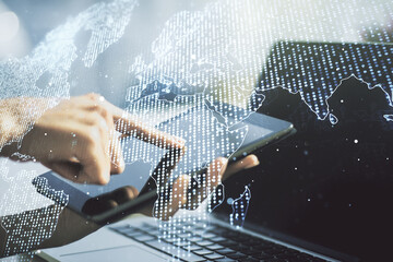 Wall Mural - double exposure of abstract digital world map and finger clicks on a digital tablet on background, r