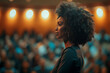 © Rattanapon - Confident black African American business woman speaking in auditorium at corporate event.