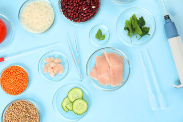 Wall Mural - Food quality control. Petri dishes with different products, pipettes and tweezers on light blue background, flat lay