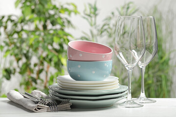 Wall Mural - Beautiful ceramic dishware, glasses and cutlery on white table outdoors