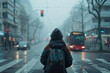 © yaqui_villegas - A solitary woman awaits transportation at a bus stop on a foggy, atmospheric day in the city