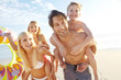 © Grady Reese/peopleimages.com - Playing, piggyback and family with kids at beach in swimsuit for holiday trip, summer vacation or weekend getaway. Love, happy parents and children for travel, adventure or bonding together at sea