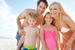 © Grady Reese/peopleimages.com - Portrait, smile and family with children at beach in swimsuit for holiday trip, summer vacation or weekend getaway. Love, happy people and young kids for travel, adventure or bonding together at sea