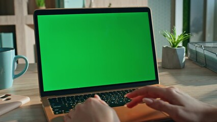 Woman using touchpad chroma key laptop surfing internet at workplace close up. 