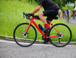 © ChiccoDodiFC - cyclist powerfully pedaling a red road bike during a road race