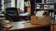 © tantawat - A desk with a termination letter prominently displayed, and a box filled with personal belongings ready to be taken away. The scene captures the reality of job loss in a business setting.