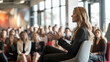 © Michael - Professional woman speaker engaging audience at a business seminar